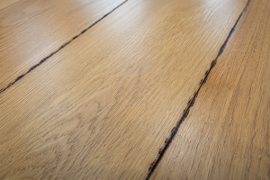 Hardwood floor stain bleed back showing streaks and stain migration through the wood finish surface