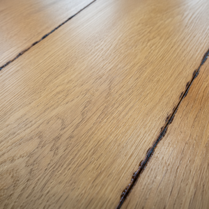 Hardwood floor stain bleed back showing streaks and stain migration through the wood finish surface