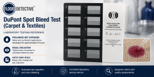 DuPont Spot Bleed laboratory test showing the AATCC Gray Scale used to evaluate carpet dye migration and color bleeding after prolonged wet exposure.