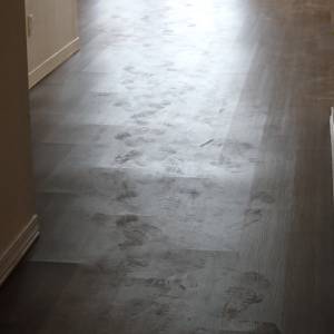 Buckling in vinyl plank flooring showing lifted or tented planks