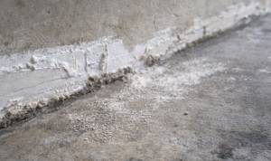 Drywall dust and sanding residue on concrete