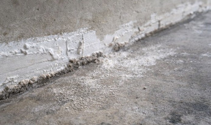 Drywall dust and sanding residue on concrete